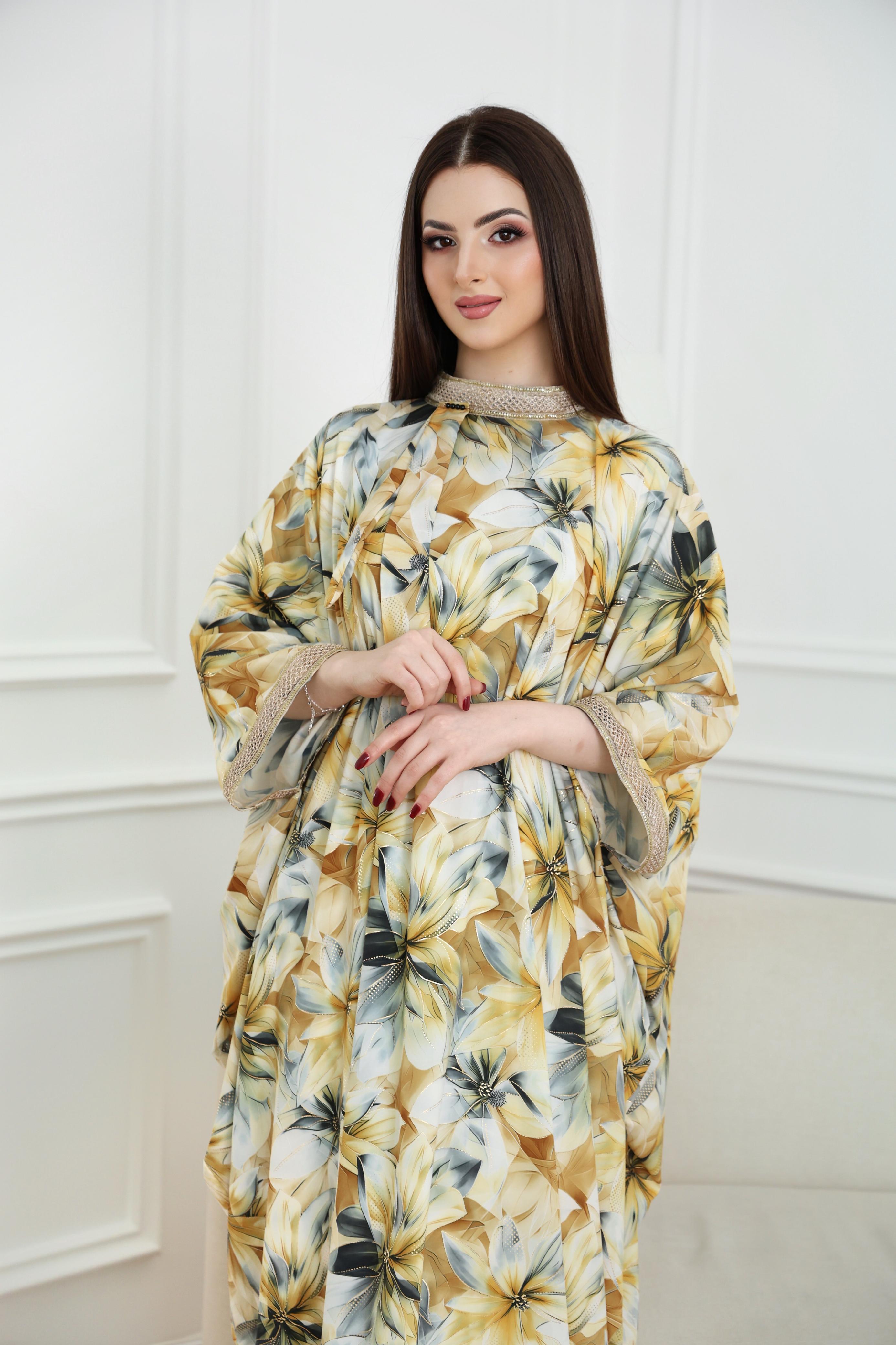 Woman wearing a floral dress against a white wall