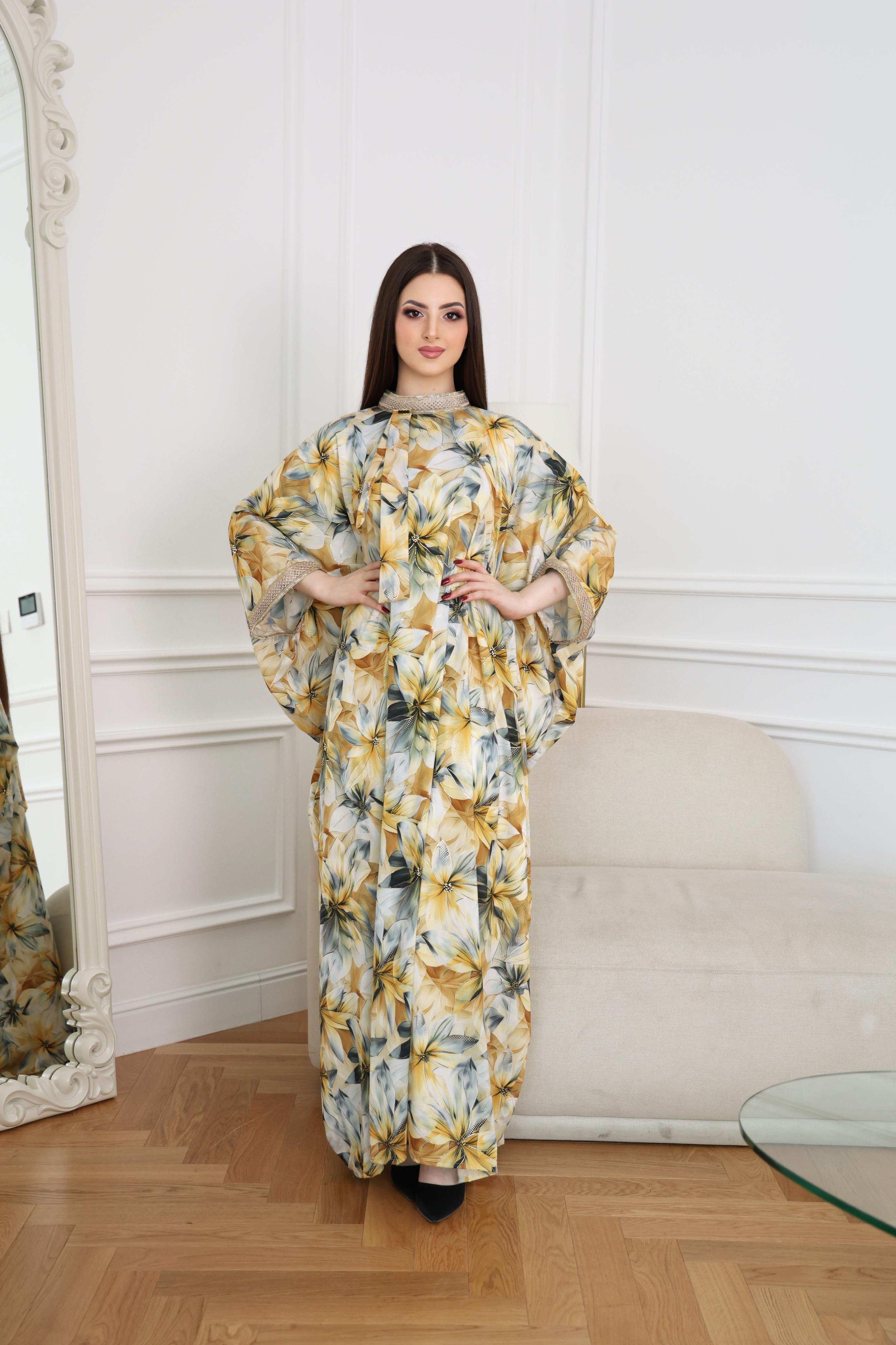 Closed white abaya with yellow and blue floral embroidery and hive detail neckline and sleeve endings, front view